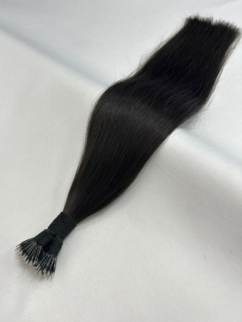 1B Natural Black nano tip hair extensions with ultra-fine tips for a lightweight, seamless blend. A soft black shade for a natural, long-lasting look.