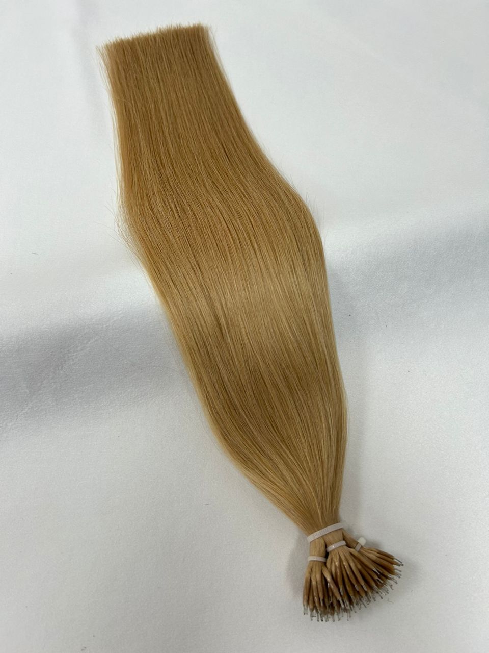 27 Honey Blonde nano tip hair extensions with fine, lightweight nano tips for a seamless application. A warm, golden blonde shade for a sun-kissed finish.