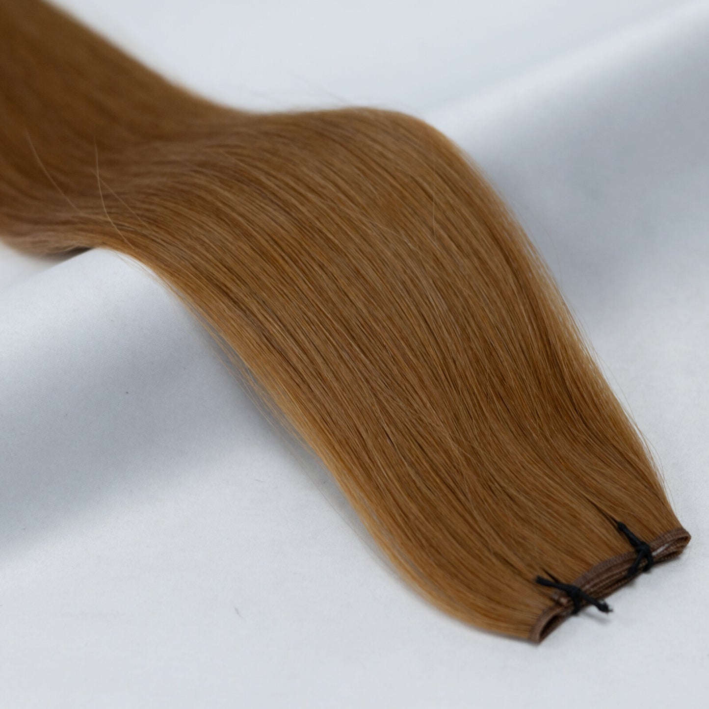 Vibrant copper brown hair extensions with rich, warm auburn hues. Available in Weft, Tape, Nano Tip, and Invisi Weft.