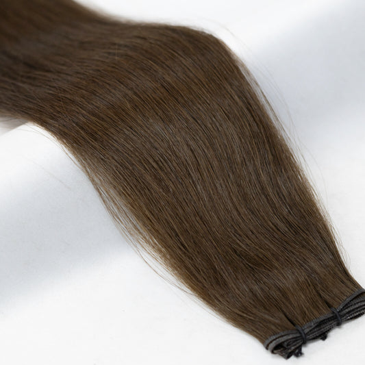 Warm chestnut brown hair extensions with natural, rich undertones. Available in Weft, Tape, Nano Tip, and Invisi Weft.
