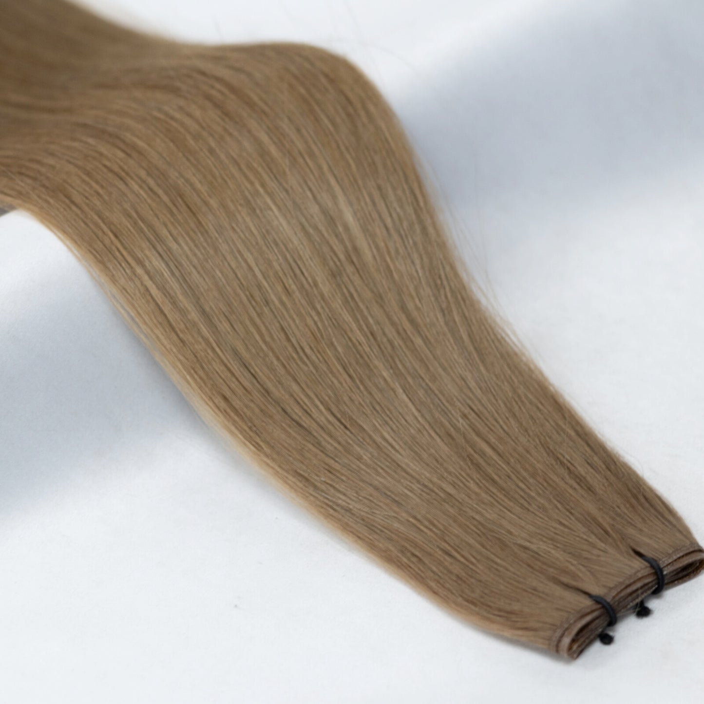 5 hair extensions in a natural medium brown shade, perfect for a subtle, everyday brunette look. Available in Weft, Tape, Nano Tip, and Invisi Weft.