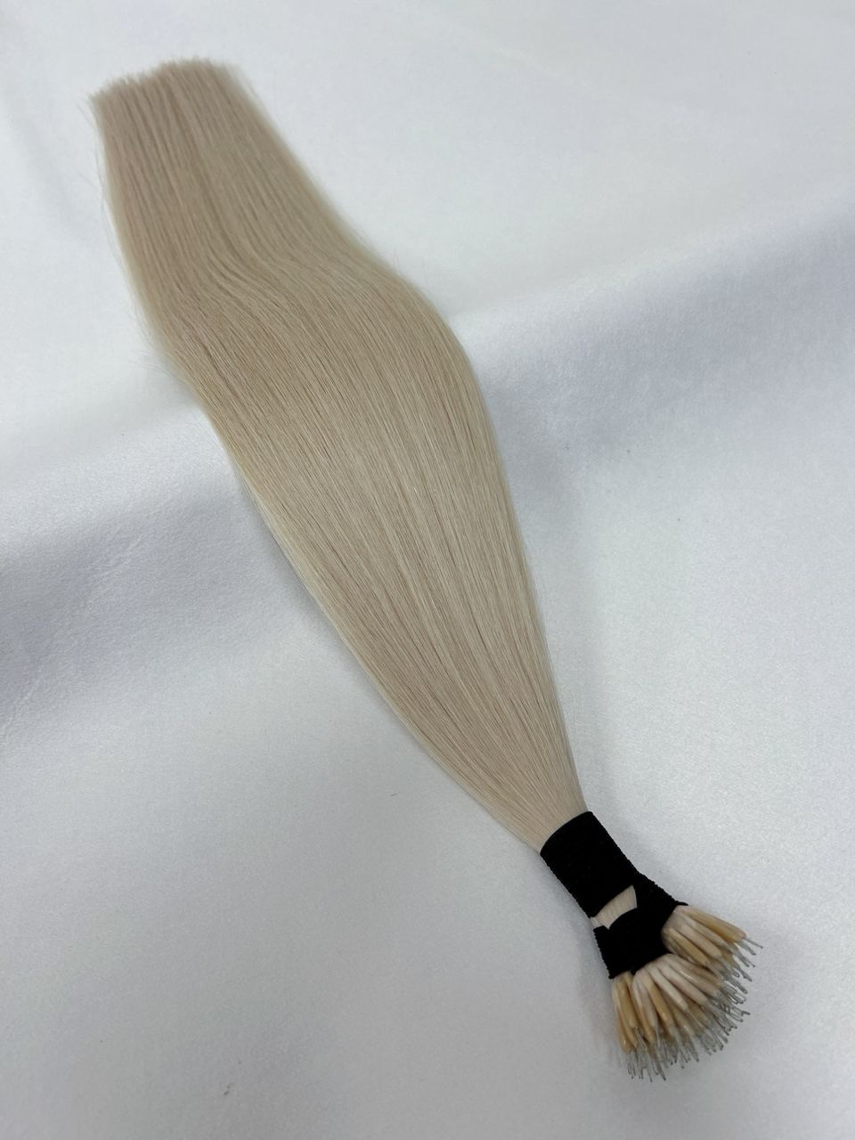 60 Platinum Blonde nano tip hair extensions featuring ultra-fine, discreet tips for a seamless, lightweight blend. A cool-toned platinum blonde shade for a flawless finish.