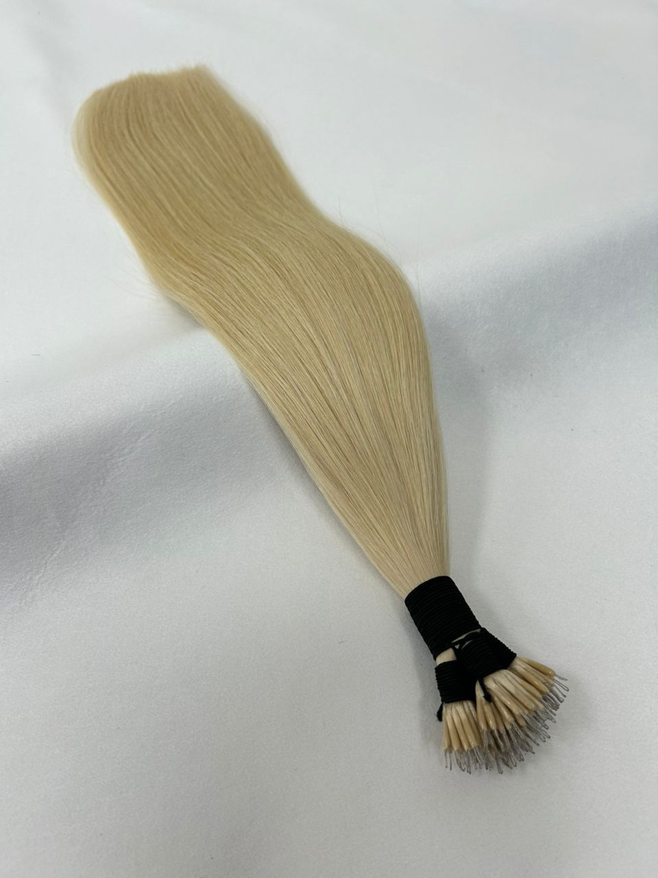 Premium 60 Platinum Blonde nano tip hair extensions featuring ultra-fine, discreet tips for a seamless, natural blend. Perfect for a lightweight, long-lasting hold.