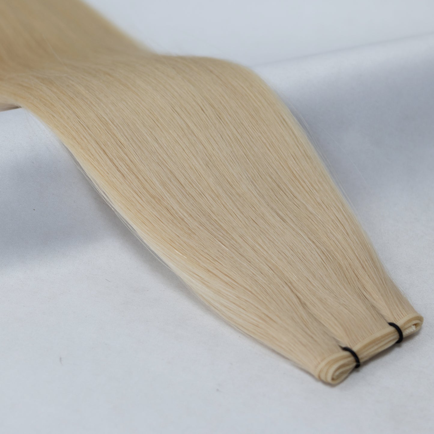 613 Platinum Blonde nano tip hair extensions featuring fine, lightweight nano tips for a natural, seamless blend. A warm platinum shade for a soft, golden blonde finish.