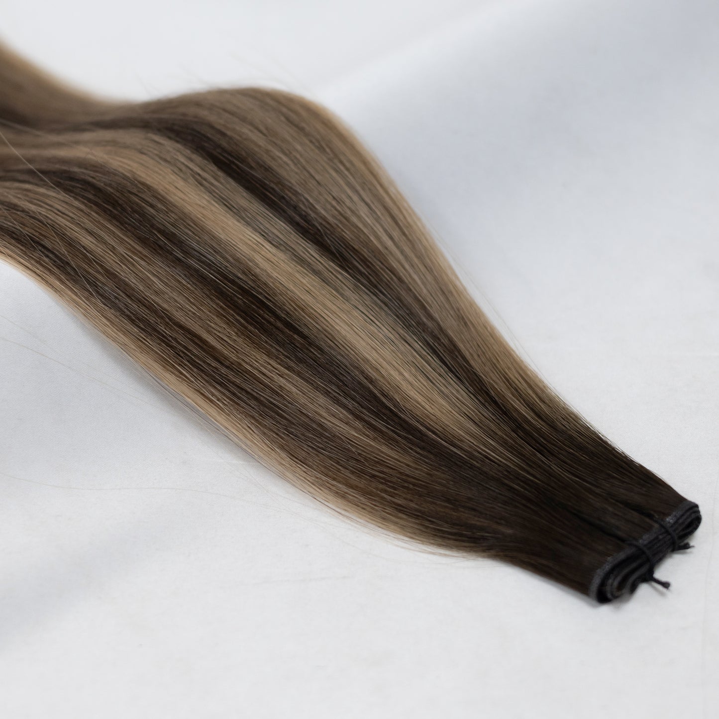 DC hair extensions in a deep, natural brown shade for a flawless, long-lasting brunette look. Available in Weft, Tape, Nano Tip, and Invisi Weft.