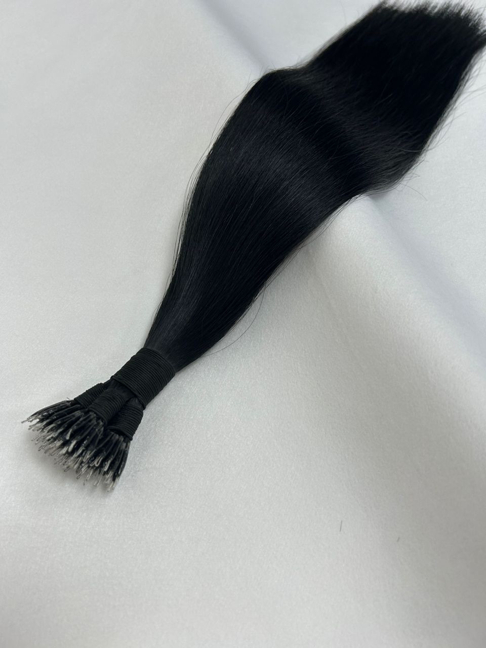 EBONY Signature Black nano tip hair extensions (#1), a rich jet black shade with ultra-fine, lightweight tips for a seamless and natural blend.