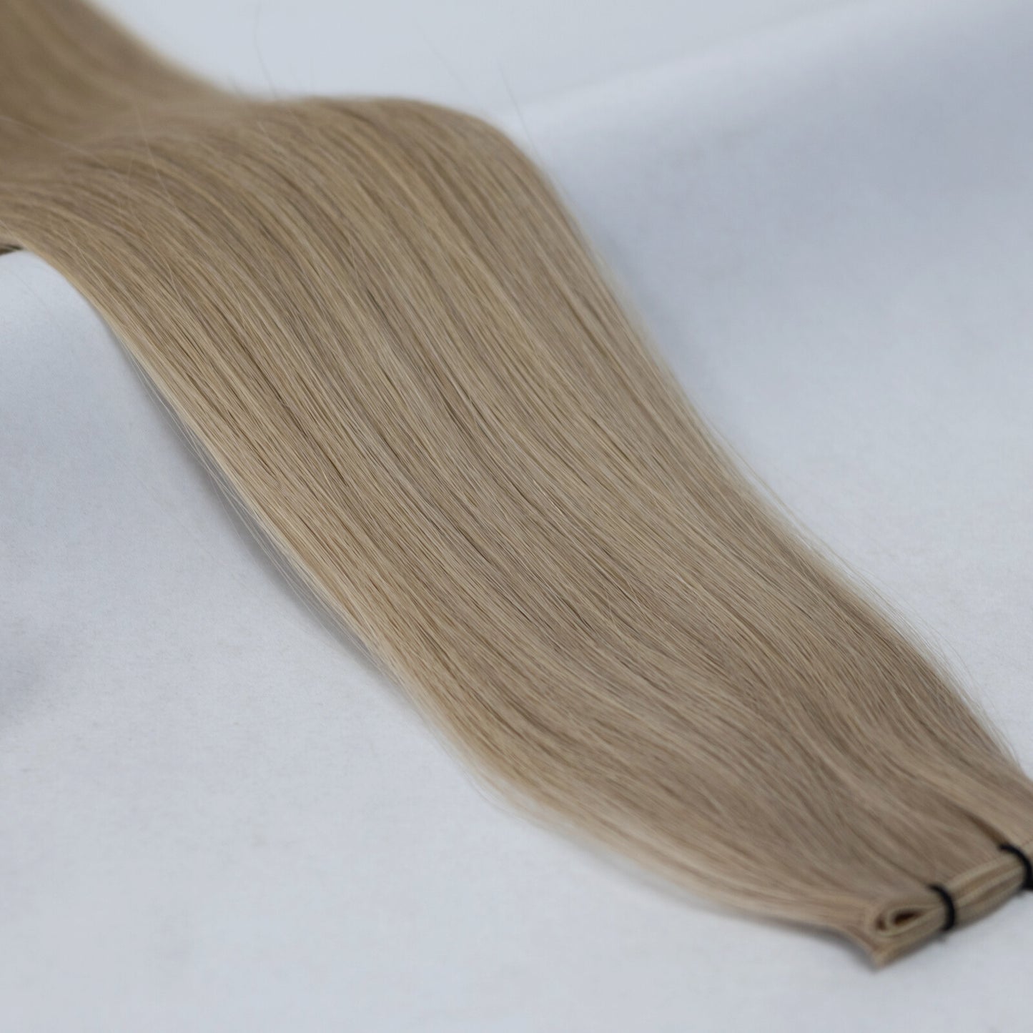 A soft, natural blend of ash blonde and beige blonde hair extensions for a seamless, multi-tonal look. Available in Weft, Tape, Nano Tip, and Invisi Weft.