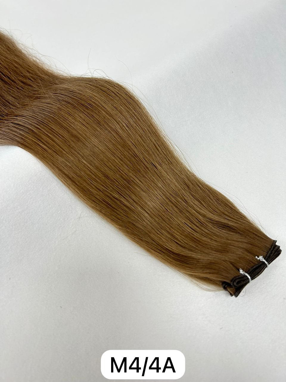 M4/4A hair extensions in a deep, natural dark brown shade for a flawless, full-bodied brunette look. Available in Weft, Tape, Nano Tip, and Invisi Weft.