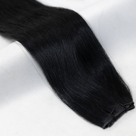 Premium jet black hair extensions from Mane Attraction, named after the founder Ebony. Available in Weft, Tape, Nano Tip, and Invisi Weft.